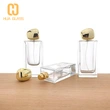 Botella de perfume rectangular de vidrio de 60 ml, 80 ml y 100 ml con tapa de piedra dorada