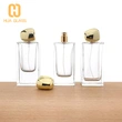 Botella de perfume rectangular de vidrio de 60 ml, 80 ml y 100 ml con tapa de piedra dorada
