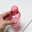 Frasco de perfume rosa transparente de vidrio de 100 ml con tapa de bola