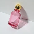 Frasco de perfume rosa transparente de vidrio de 100 ml con tapa de bola