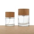 Frasco de perfume redondo de vidrio de 50 ml y 100 ml con tapa de madera