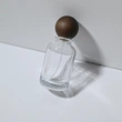 Venta al por mayor botella de perfume redonda de vidrio de 30 50 100 ml con tapa de bola