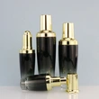 black skincare cosmetic glass bottle set with pump lotion cap