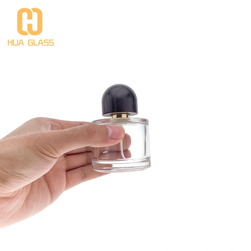 Frasco de perfume de vidrio redondo pequeño de 50 ml y 100 ml con tapa de madera  