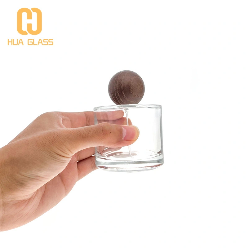 50 مل 100 مل زجاجة عطر زجاجية صغيرة مستديرة مع غطاء خشبي مستدير