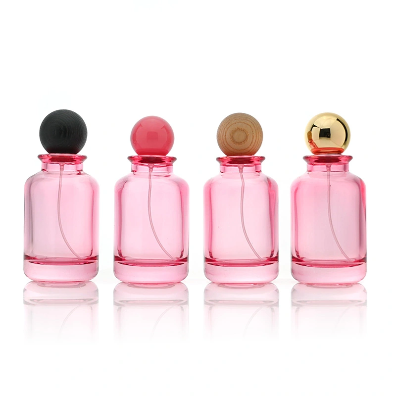 Frasco de perfume rosa transparente de vidrio de 100 ml con tapa de bola