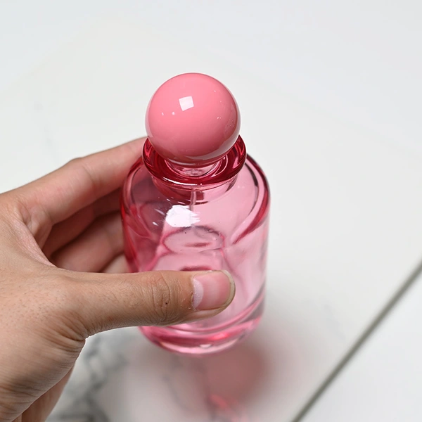 Frasco de perfume rosa transparente de vidrio de 100 ml con tapa de bola