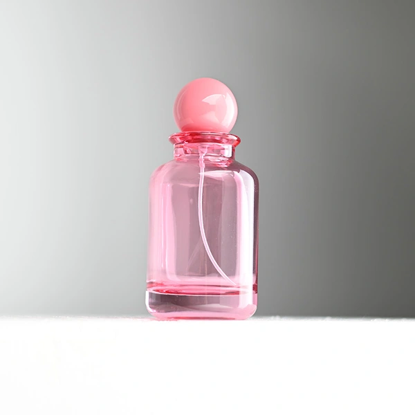 Frasco de perfume rosa transparente de vidrio de 100 ml con tapa de bola