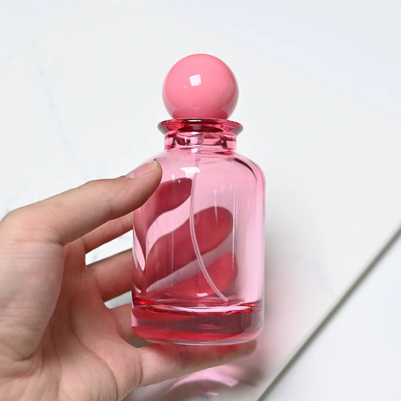 Frasco de perfume rosa transparente de vidrio de 100 ml con tapa de bola