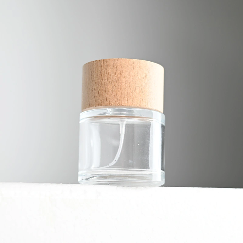 Frasco de perfume redondo de vidrio de 50 ml y 100 ml con tapa de madera  