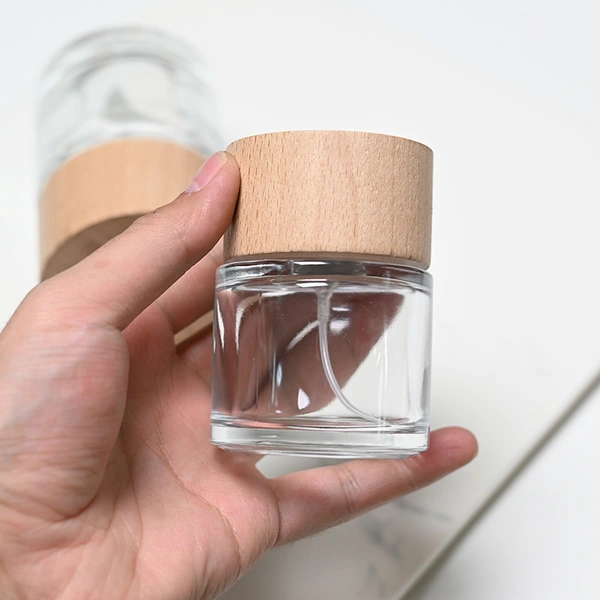 Frasco de perfume redondo de vidrio de 50 ml y 100 ml con tapa de madera
