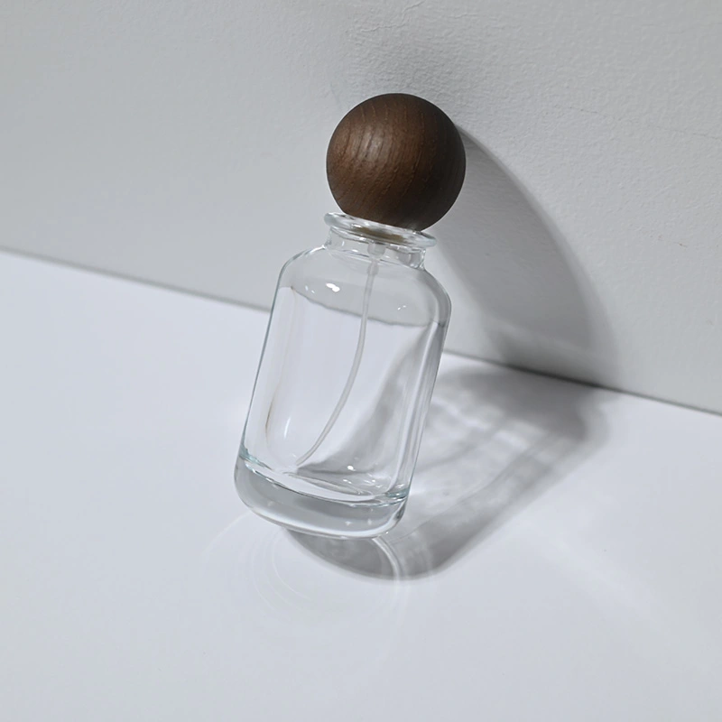 Venta al por mayor botella de perfume redonda de vidrio de 30 50 100 ml con tapa de bola  