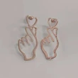 Simple hollow heart earrings for women, personalized European and American exaggerated metal earrings, gesture temperament earrings
