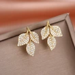  New style of diamond leaf earrings for women, exquisite and small, versatile earrings with floral design and aristocratic style