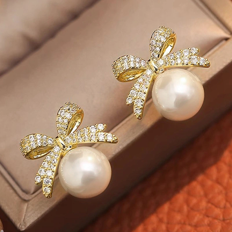  Japanese and Korean bow earrings for women, elegant and sweet accessories, imitation pearl design, hot sale
