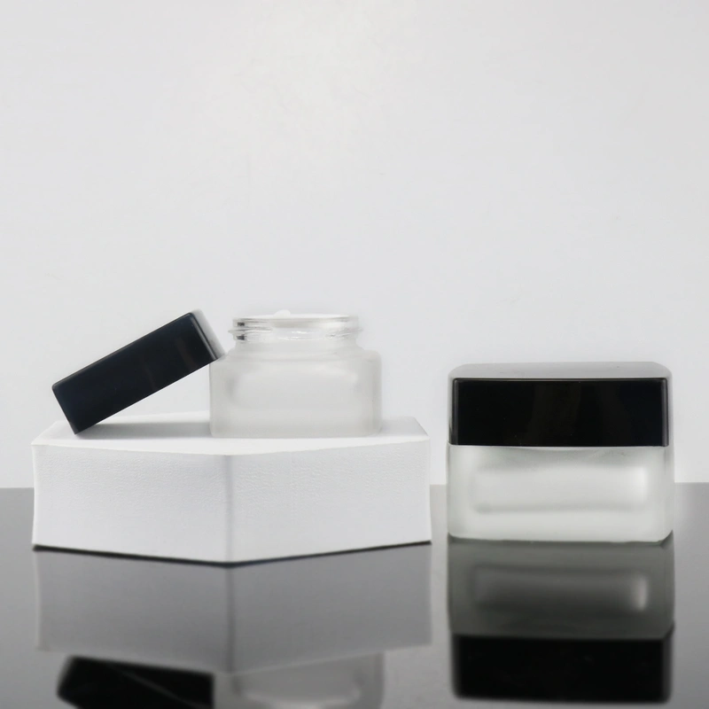 empty square clear cosmetic face lotion cream glass bottle jar