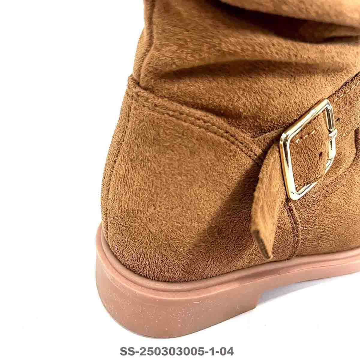 Closeup shot of kids boot metal buckle strap and soft suede texture