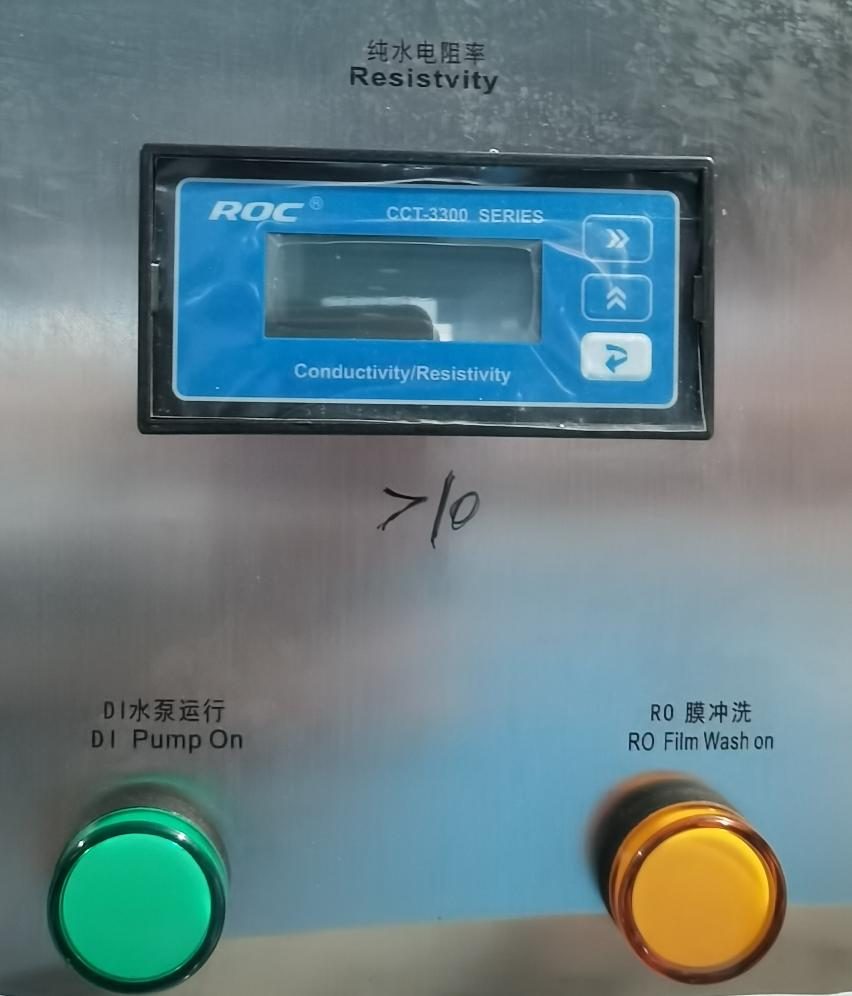 Resistivity monitor on a DI water machine with the DI Pump on lamp and a handwritten mark of 10