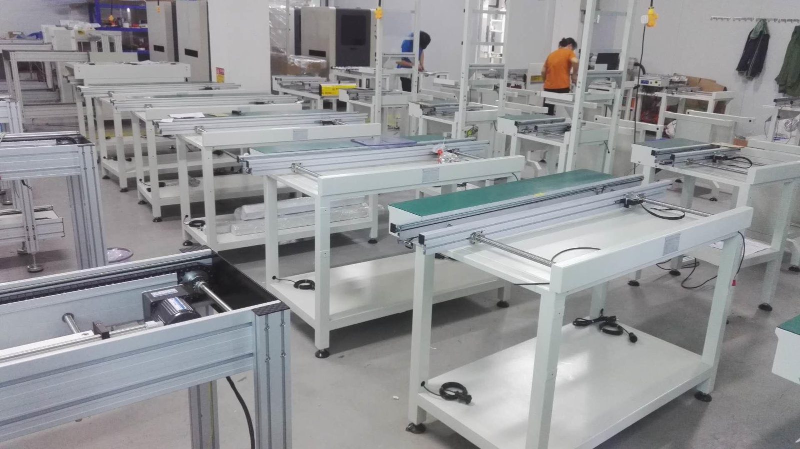 Row of magazine loader and conveyor units in the workshop